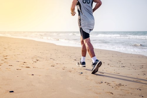 Health man jogging on the beach